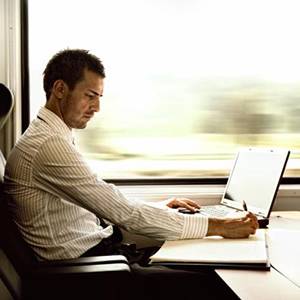 Man-using-laptop-on-a-train